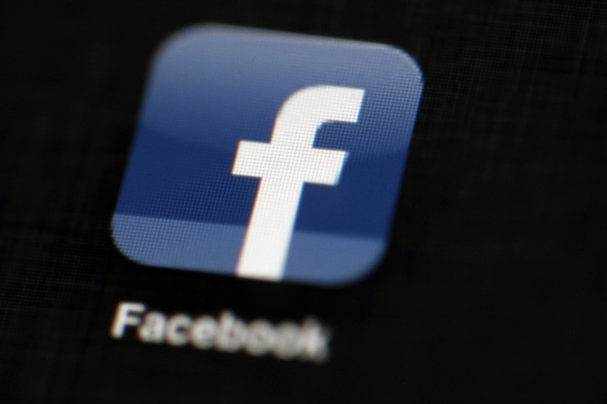 FILE - In this May 16, 2012, file photo, the Facebook logo is displayed on an iPad in Philadelphia. Facebook is taking new measures to curb the spread of fake news on its huge and influential social n ...