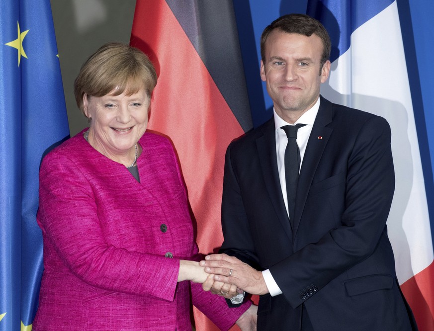 French President Emmanuel Macron, right, and German Chancellor Angela Merkel shake hands after a press conference in Berlin, Germany, Monday, May 15, 2017. Macron and Merkel pledged Monday to work clo ...