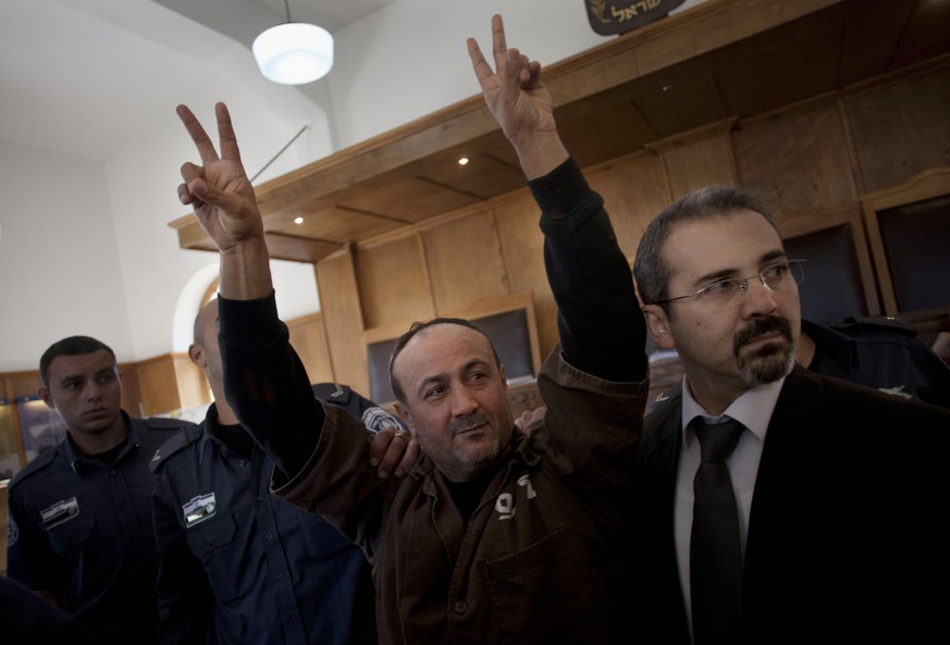 FILE - In this Wednesday, Jan. 25, 2012 file photo, senior Fatah leader Marwan Barghouti makes the victory sign in front of the media during his arrival to testify in a trial at a Jerusalem court. On  ...