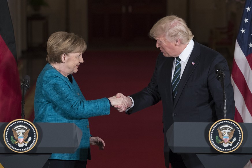 epa05854854 US President Donald J. Trump (R) shakes hands with Chancellor of Germany Angela Merkel (L) during a joint press conference in the East Room of the White House in Washington, DC, USA, 17 Ma ...