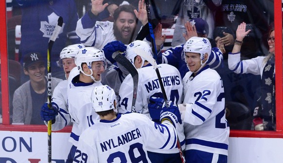 Toronto Maple Leafs center Auston Matthews is congratulated by teammates on his hat trick after scoring a goal early in the second period against the Ottawa Senators in an NHL hockey game Wednesday, O ...