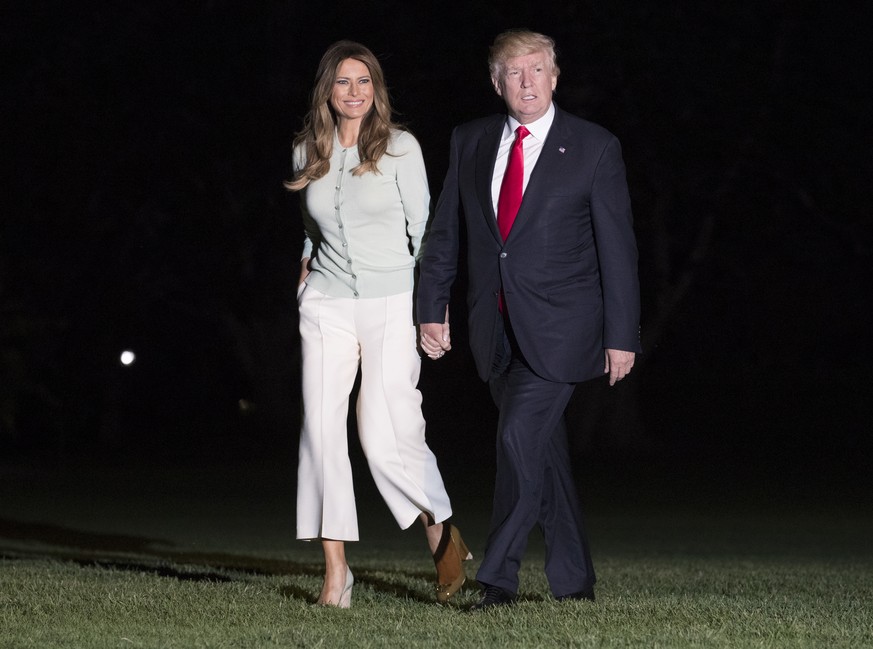 President Donald Trump and first lady Melania Trump walk from Marine One across the South Lawn to the White House in Washington, Saturday, May 27, 2017, as they return from Sigonella, Italy. (AP Photo ...