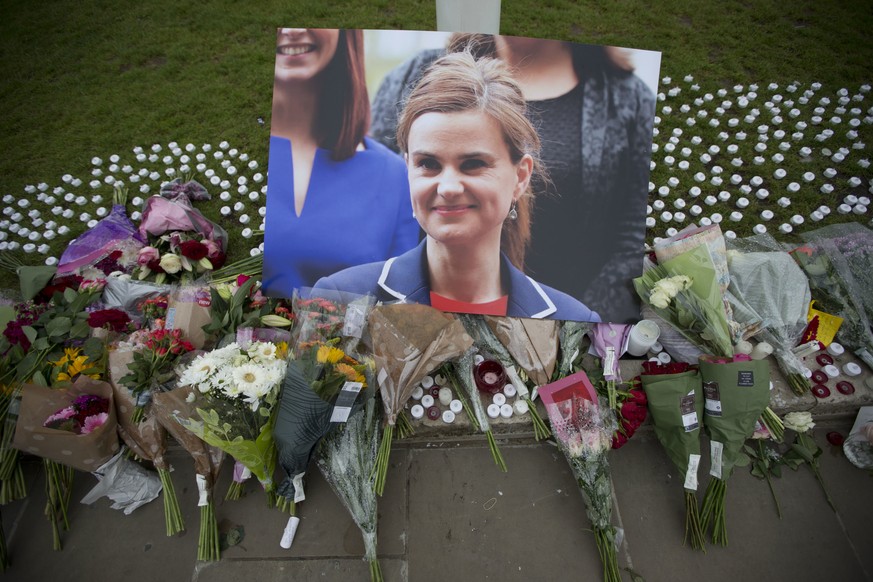 FILE - This is a Friday, June 17, 2016, file photo of an image and floral tributes for Jo Cox, in Parliament Square, outside the House of Parliament in London, after the 41-year-old British Member of  ...
