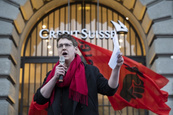 epa10534148 Nicola Siegrist, President of Juso party, speaks to people protesting on occasion of the takeover of Credit Suisse by UBS, in Zurich, Switzerland, 20 March 2023. Swiss bank UBS takes over  ...