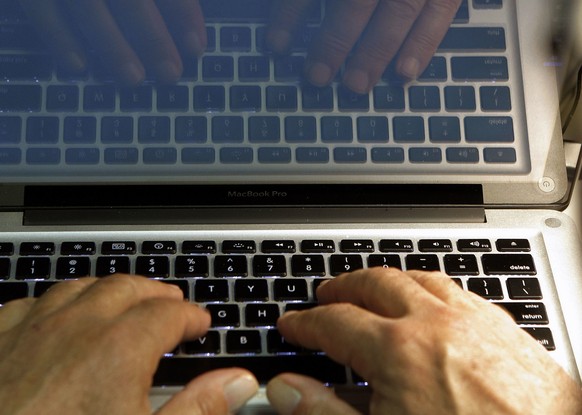 FILE - In this Feb. 27, 2013, file photo illustration, hands type on a computer keyboard in Los Angeles. Spring is a great time to clear out your digital clutter and make sure that you&#039;re adequat ...