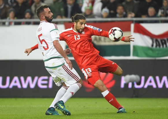 Switzerland&#039;s Ricardo Rodriguez, right, scores a goal next to Attila Fiola of Hungary during the World Cup Group B qualifying soccer match between Hungary and Switzerland in Groupama Arena in Bud ...