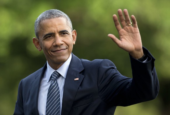 FILE - In this July 5, 2016 photo, President Barack Obama waves as he walks across the South Lawn of the White House, in Washington, as he returns from Charlotte, N.C. where he participated in a campa ...