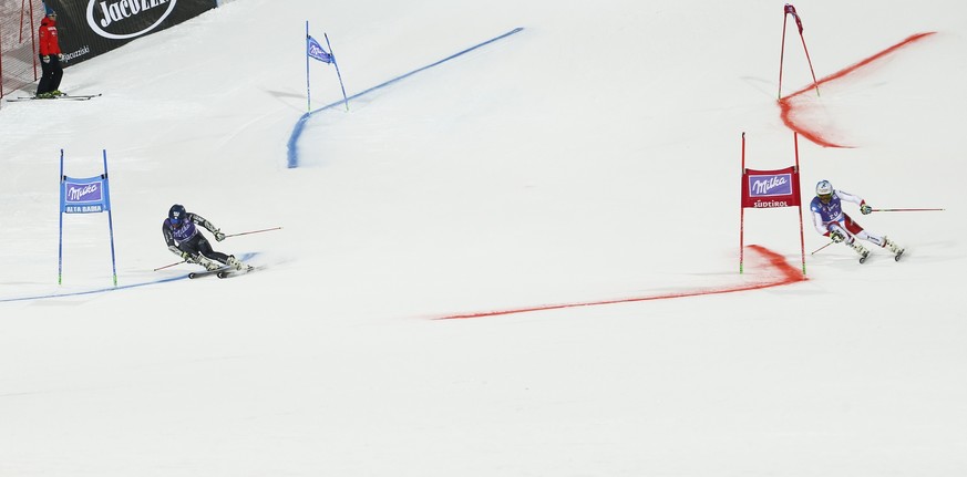 France&#039;s Mathieu Faivre , left, and Switzerland&#039;s Gino Caviezel compete during an alpine ski, men&#039;s World Cup parallel giant slalom, in Alta Badia Italy, Monday, Dec. 19, 2016. (AP Phot ...