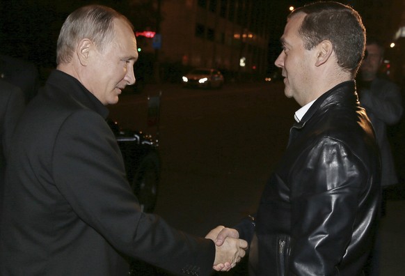 Russian President Vladimir Putin, left, shakes hands with Prime Minister Dmitry Medvedev at United Party&#039;s election headquarters in Moscow, Russia, Sunday, Sept. 18, 2016. Early results on Sunday ...