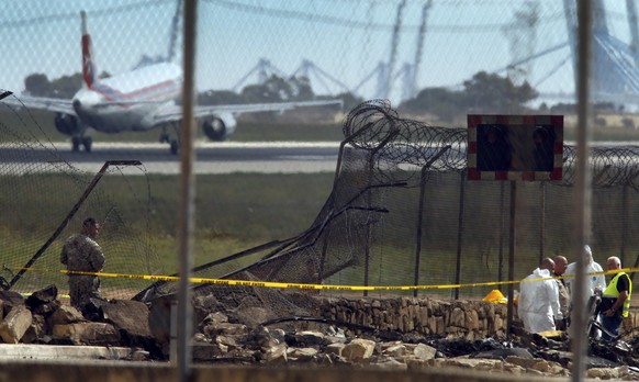 Investigators and rescue services at the scene of a plane crash at the airport in Valletta, Malta, 24 October 2016. REUTERS/Darrin Zammit Lupi MALTA OUT. NO COMMERCIAL OR EDITORIAL SALES IN MALTA.