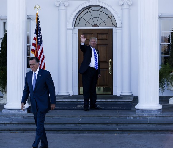 epa05638800 Former Massachusetts Governor Mitt Romney (L) leaves after meeting with US President-elect Donald Trump (R) and Vice President-elect Mike Pence (unseen) at the clubhouse at Trump Internati ...