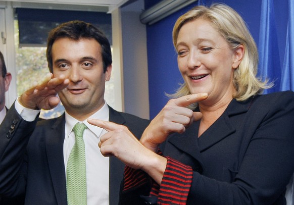 FILE - In this Oct. 6, 2011 file photo, French far-right Front National party leader Marine Le Pen and her director for strategy Florian Philippot gesture during a presentation of the Front National S ...