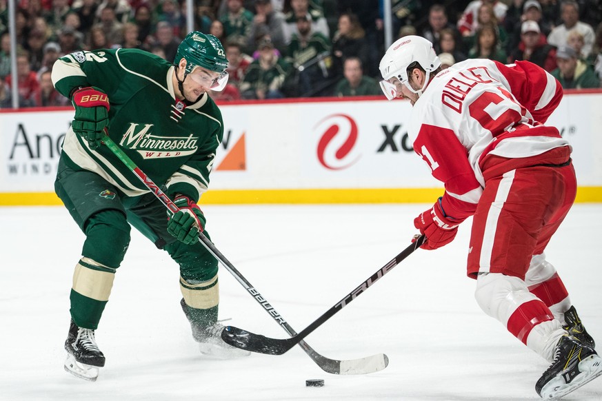 Feb 12, 2017; Saint Paul, MN, USA; Minnesota Wild forward Nino Niederreiter (22) plays the puck in front of Detroit Red Wings defenseman Xavier Ouellet (61) during the first period at Xcel Energy Cent ...