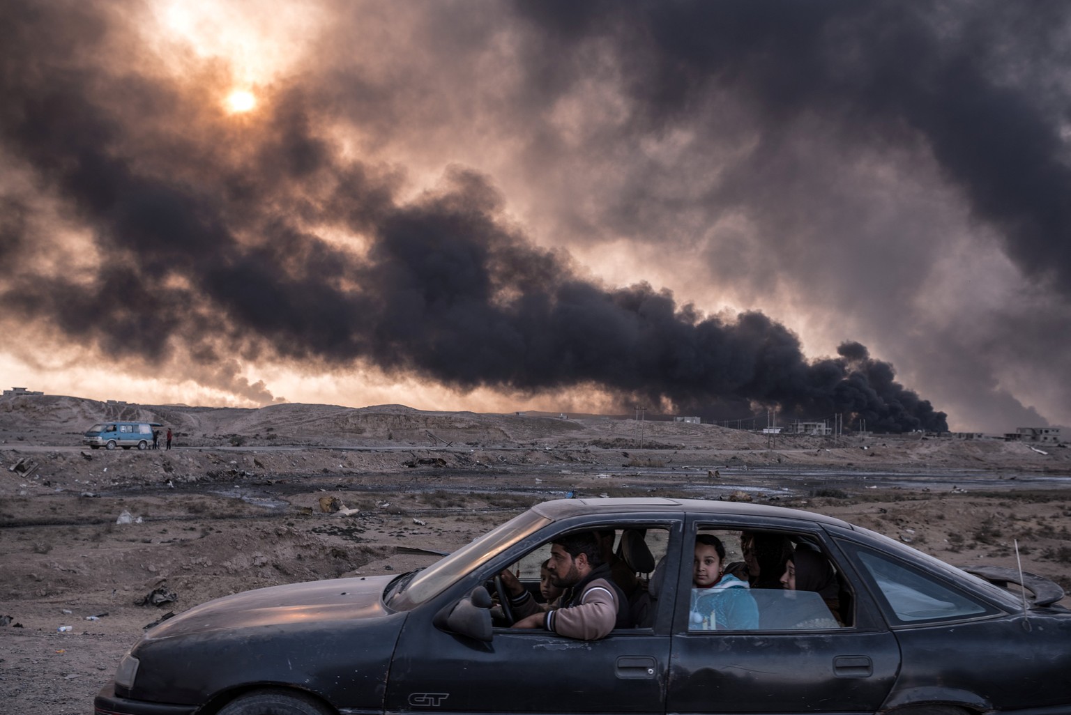 A family flees the fighting in Mosul, IraqÕs second-largest city, as oil fields burned in Qayyara, Iraq, on November 12, 2016. In its sixth week, the military campaign to retake Mosul from the Islamic ...