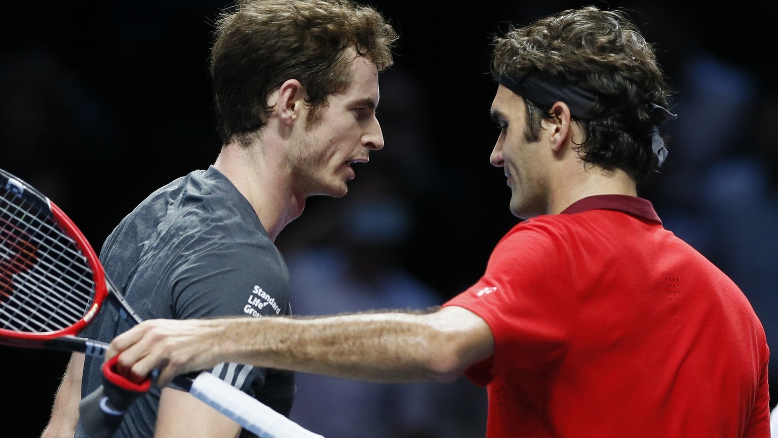 Roger Federer of Switzerland (R) embraces Andy Murray of Britain (L) after defeating Murray in their tennis match at the ATP World Tour finals at the O2 Arena in LondonNovember 13, 2014. REUTERS/Stefa ...