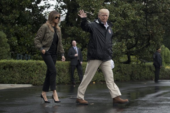 epa06170119 US President Donald J. Trump (R) and First Lady Melania Trump (L) walk out of the South Portico to depart the South Lawn of the White House by Marine One, in Washington, DC, USA, 29 August ...