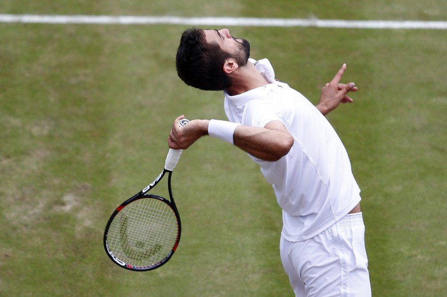 epa06083235 Marin Cilic of Croatia serves to Gilles Muller of Luxembourg in their quarter final match during the Wimbledon Championships at the All England Lawn Tennis Club, in London, Britain, 12 Jul ...
