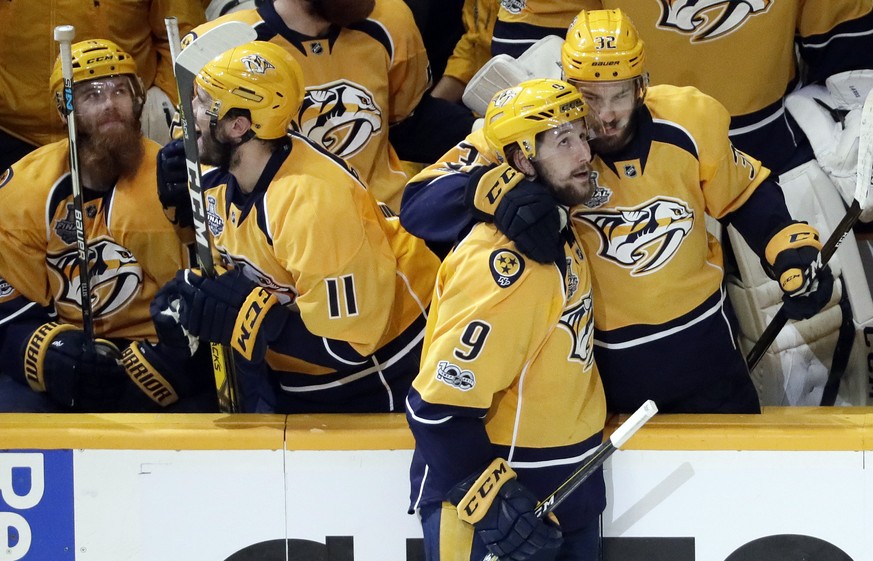 Nashville Predators left wing Filip Forsberg (9), of Sweden, is congratulated by Frederick Gaudreau (32) after Forsberg scored an empty net goal against the Pittsburgh Penguins during the third period ...
