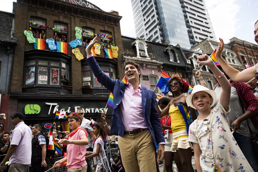 Prime Minister Justin Trudeau, his wife Sophie Gregoire Trudeau, right, and their children Ella-Grace and Xavier walk in the Pride parade in Toronto, Sunday, June 25, 2017. (Mark Blinch/The Canadian P ...