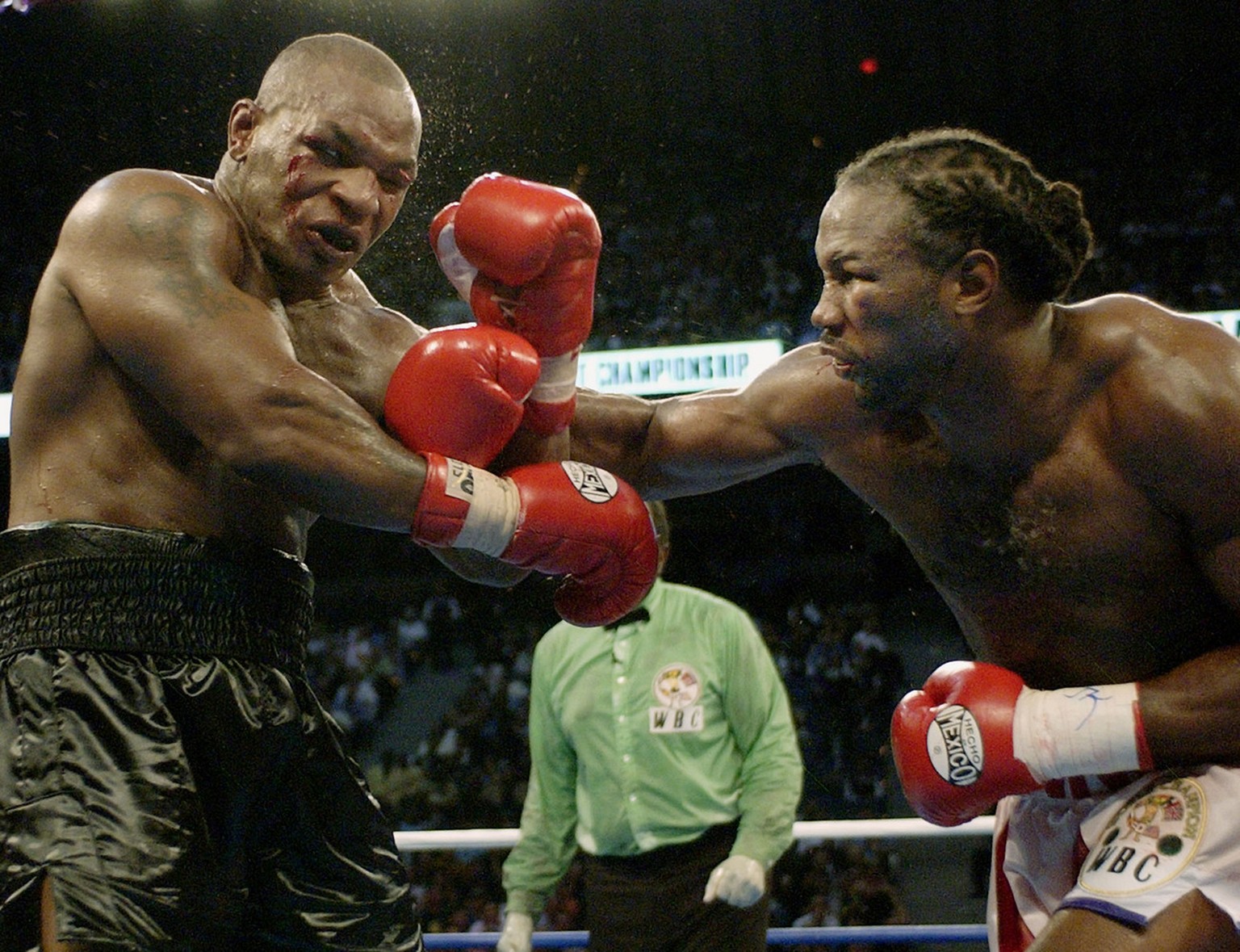 Mike Tyson, left, reels back after a right from Lennox Lewis during the seventh round of their WBC/IBF heavyweight championship bout at The Pyramid in Memphis, Tenn., Saturday, June 8, 2002. Lewis kno ...