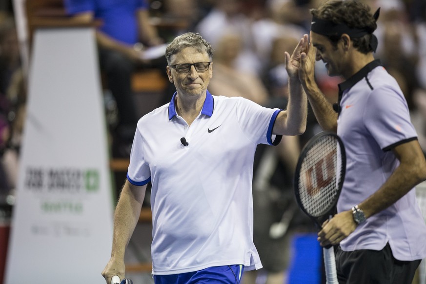 epa05936353 Microsoft Co-Founder Bill Gates (L) and Roger Federer (R) react after a point during their Match for Africa 4 tennis match against Pearl Jam lead guitarist Mike McCready and John Isner at  ...