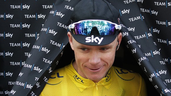 Britain&#039;s Chris Froome, wearing the overall leader&#039;s yellow jersey, leaves the team bus prior to the start of the nineteenth stage of the Tour de France cycling race over 222.5 kilometers (1 ...
