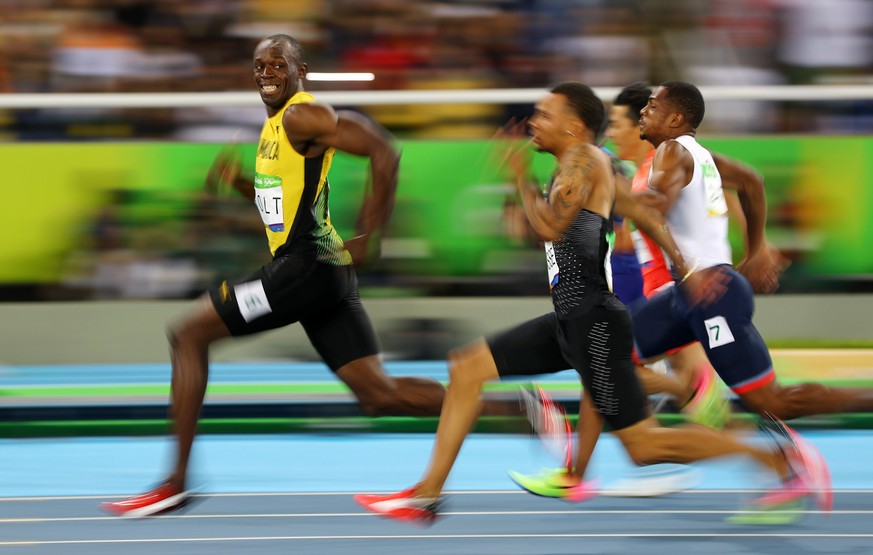 2016 Rio Olympics - Athletics - Semifinal - Men&#039;s 100m Semifinals - Olympic Stadium - Rio de Janeiro, Brazil - 14/08/2016. Usain Bolt (JAM) of Jamaica looks at Andre De Grasse (CAN) of Canada as  ...