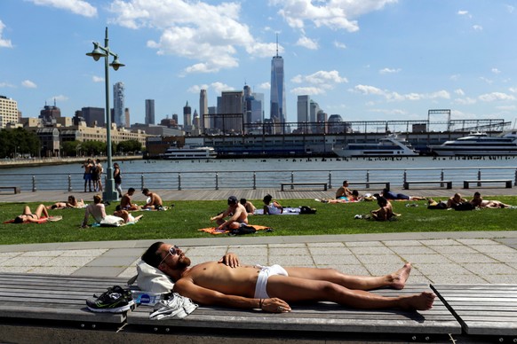 People take a sunbath during a heat wave called &quot;Heat Dome&quot; in the Manhattan borough of New York, U.S., July 23, 2016. REUTERS/Eduardo Munoz