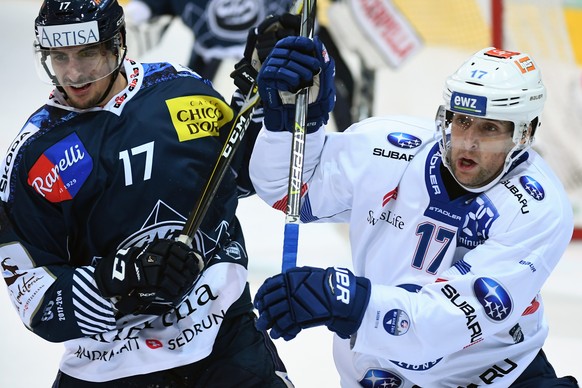 Ambri&#039;s player Igor Jelovac, left, fight for the puck with Zurich&#039;s player Drew Shore, right, during the preliminary round game of National League Swiss Championship 2017/18 between HC Ambrì ...