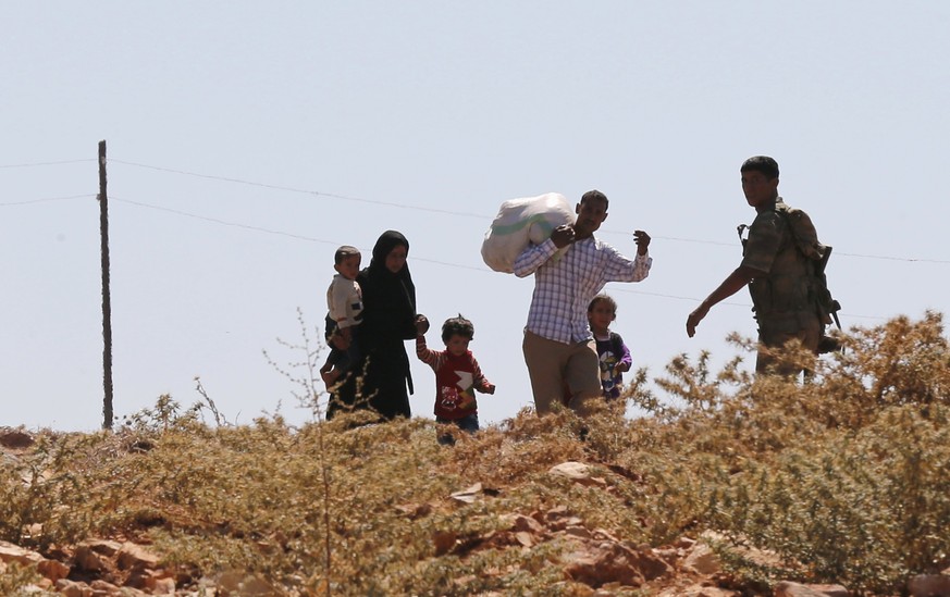 Ein türkischer Soldat stoppt syrische Flüchtlinge bei Besaslan in der Provinz Hatay. (Archivbild)