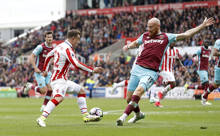 Stoke City&#039;s Xherdan Shaqiri, left, and West Ham United&#039;s James Collins battle for the ball during their English Premier League soccer match at the bet365 Stadium, Stoke, England, Saturday,  ...
