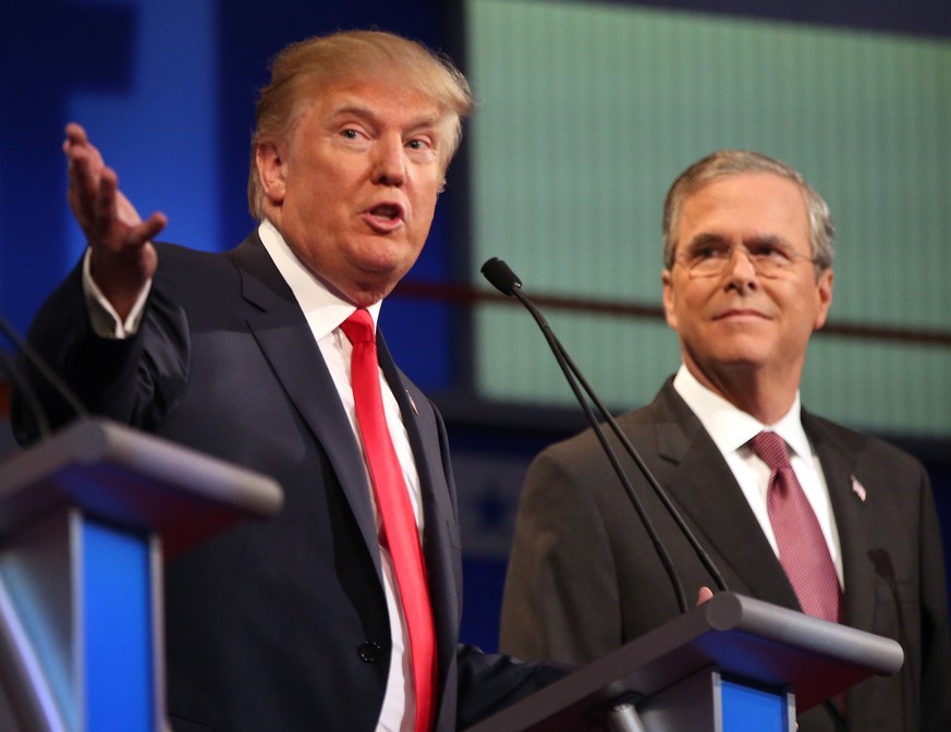 FILE - In this Aug. 6, 2015, file photo, Republican presidential candidates Donald Trump and Jeb Bush participate in the first Republican presidential debate at the Quicken Loans Arena in Cleveland. P ...