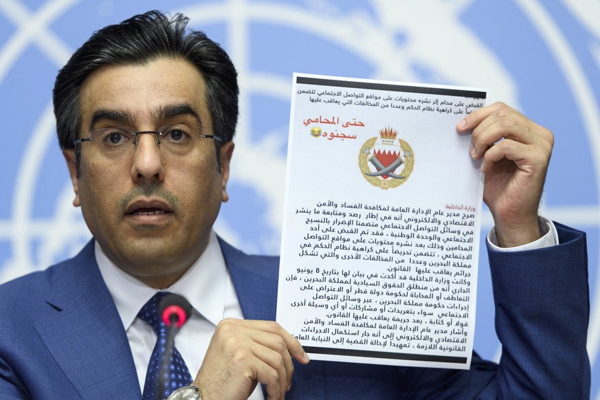 epa06031248 Ali bin Smaikh Al-Marri, Chairman of the Qatari National Human Rights Committee, holds an untranslated document written in arabic as he speaks during a press conference about the illegal b ...