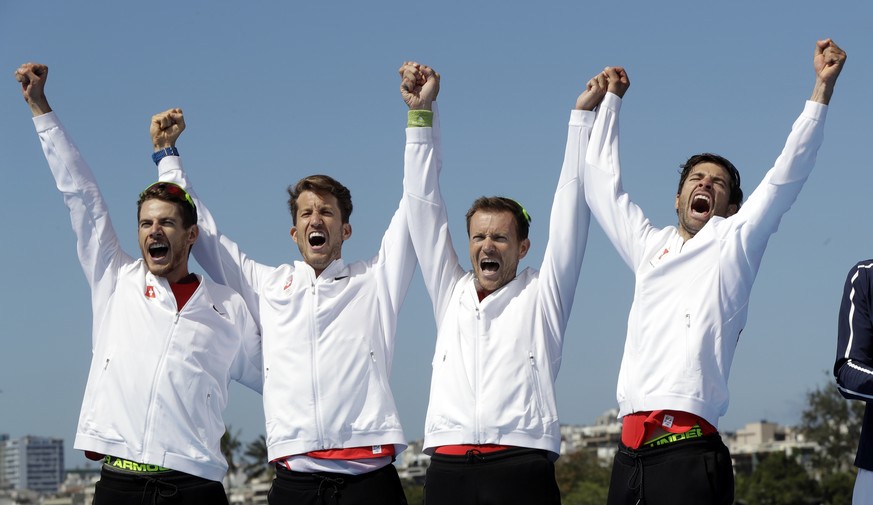 Lucas Tramer, Simon Schuerch, Simon Niepmann, and Mario Gyr, of Switzerland, celebrate after winning gold in the men&#039;s rowing lightweight four final during the 2016 Summer Olympics in Rio de Jane ...