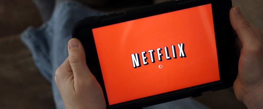 FILE - In this Friday, Jan. 17, 2014, file photo, a person displays Netflix on a tablet in North Andover, Mass. Netflix, Inc. reports financial results, Monday, July 17, 2017. (AP Photo/Elise Amendola ...