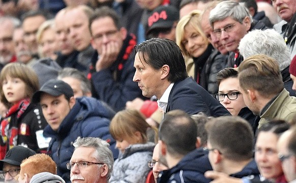Leverkusen head coach Roger Schmidt watches from the tribune beside spectators after he was sent off by the referee during the German Bundesliga soccer match between Bayer Leverkusen and TSG Hoffenhei ...