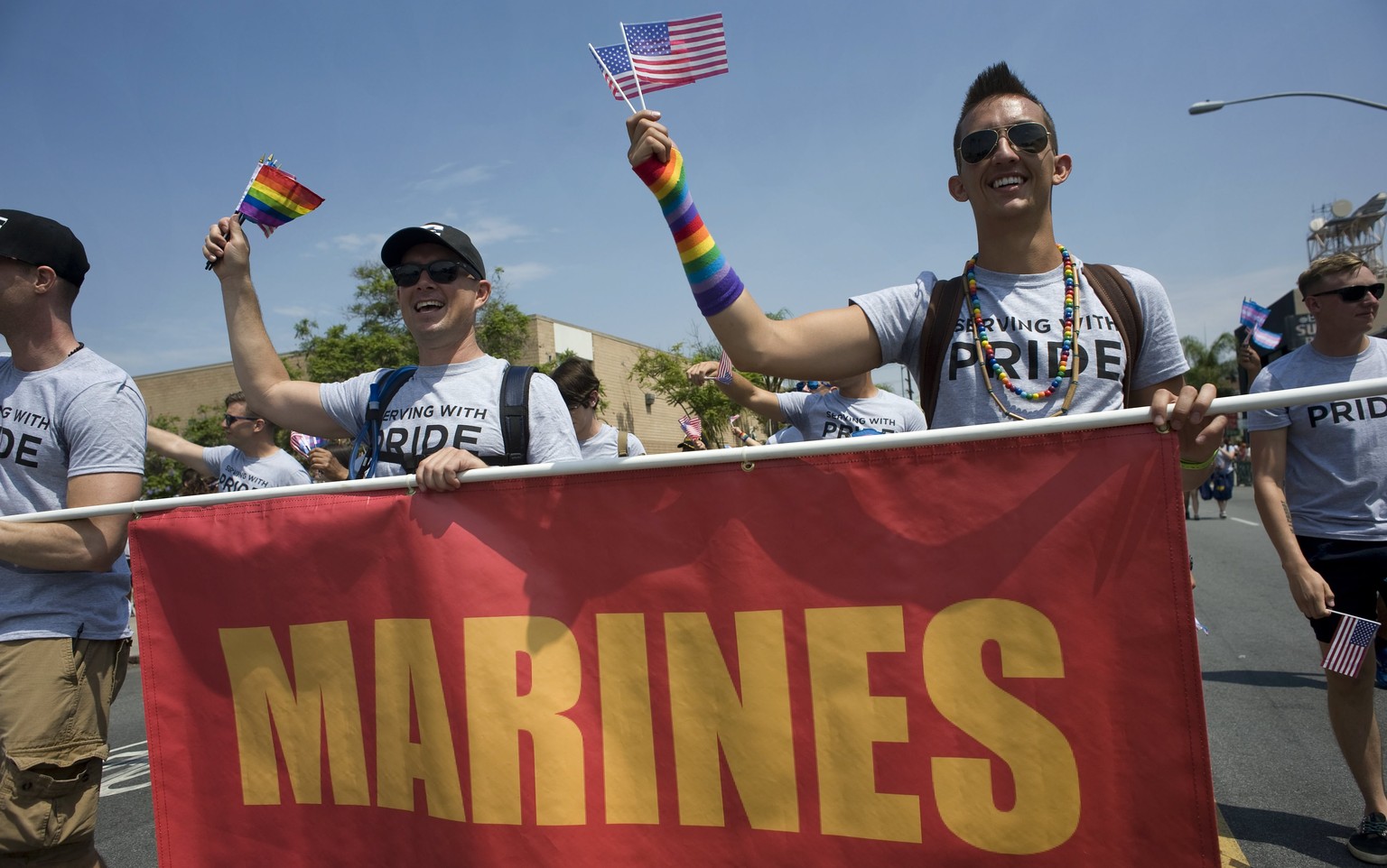 epa06090433 Active duty members of the US military participate in the 2017 San Diego LGBT Pride parade in San Diego, California, USA, 15 July 2017. This years parade was led by a contingent of interfa ...