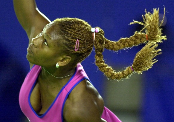 USA&#039;s Serena Williams has her pigtails flying as she serves in her center court quarter final against Martina Hingis from Switzerland at the Australian Open Tennis Championships in Melbourne, Wed ...