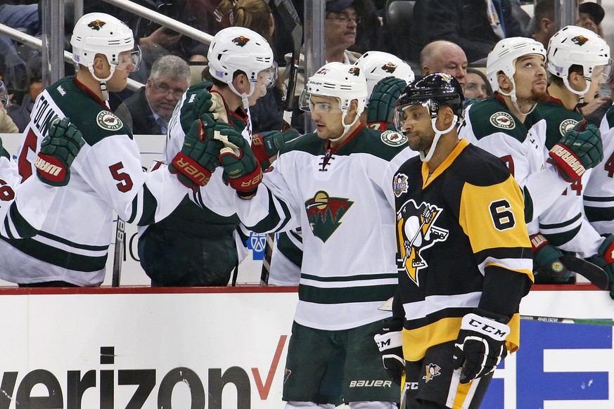 Minnesota Wild&#039;s Nino Niederreiter (22) returns to teh bench after his goal as Pittsburgh Penguins&#039; Trevor Daley (6) skates past during the second period of an NHL hockey game in Pittsburgh, ...