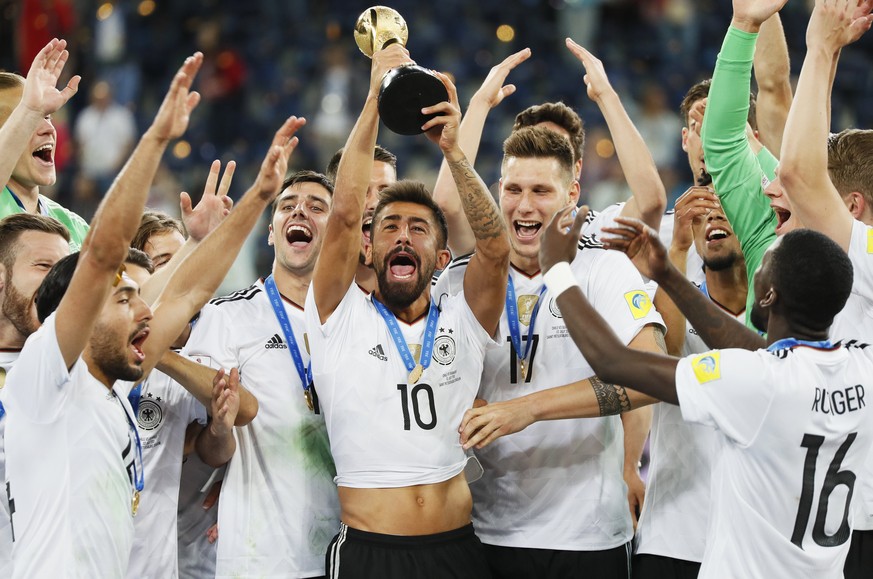 epa06062542 Kerem Demirbay of Germany raises the trophy after Germany won the FIFA Confederations Cup 2017 final match between Chile and Germany at the Saint Petersburg stadium in St.Petersburg, Russi ...