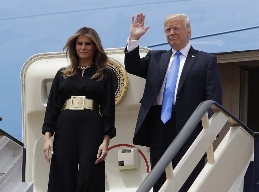 U.S. President Donald Trump, right, and first lady Melania Trump arrive at the Royal Terminal of King Khalid International Airport, Saturday, May 20, 2017, in Riyadh. (AP Photo/Evan Vucci)