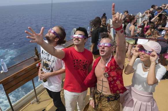 IMAGE DISTRIBUTED FOR ROYAL CARIBBEAN INTERNATIONAL - Jack Lawless, left, Joe Jonas, Cole Whittle and JinJoo of multi-platinum-selling band DNCE watched the Great American Eclipse aboard Royal Caribbe ...