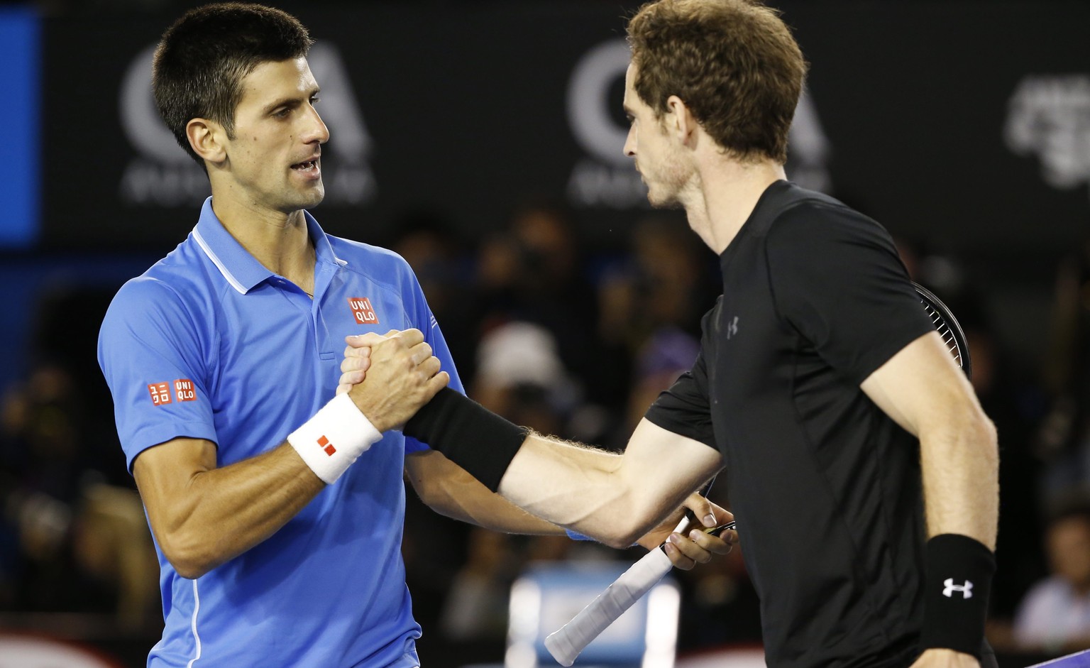 epa04598773 Novak Djokovic (L) of Serbia shakes hands with Andy Murray of Britain after Djokovic won their men&#039;s finals match at the Australian Open Grand Slam tennis tournament in Melbourne, Aus ...