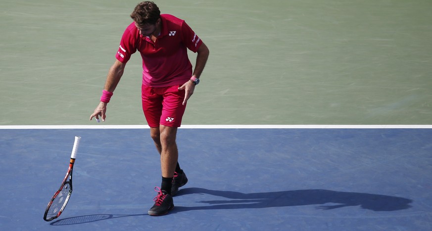 Stan Wawrinka, of Switzerland, throws down his racket in the fourth set against Illya Marchenko, of Ukraine, during the fourth round of the U.S. Open tennis tournament, Monday, Sept. 5, 2016, in New Y ...