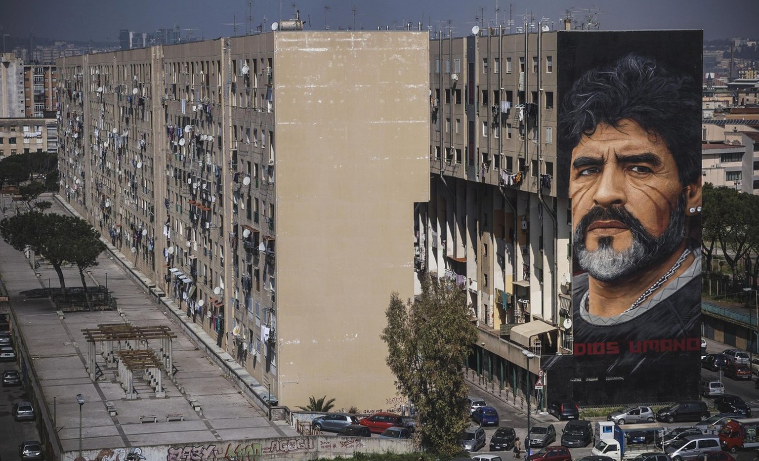 epa05861374 A huge mural by Italian artist Jorit Agoch, depicting former Argentinian soccer player Diego Armando Maradona, is seen on a building of the San Giovanni a Teduccio neighborhood in Naples,  ...