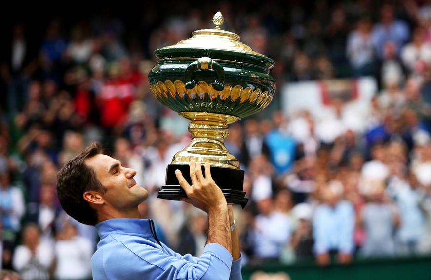 epa06049563 Roger Federer of Switzerland lifts his trophy after defeating Alexander Zverev of Germany in their final match of the ATP tennis tournament in Halle, Germany, 25 June 2017. EPA/TYLER LARKI ...