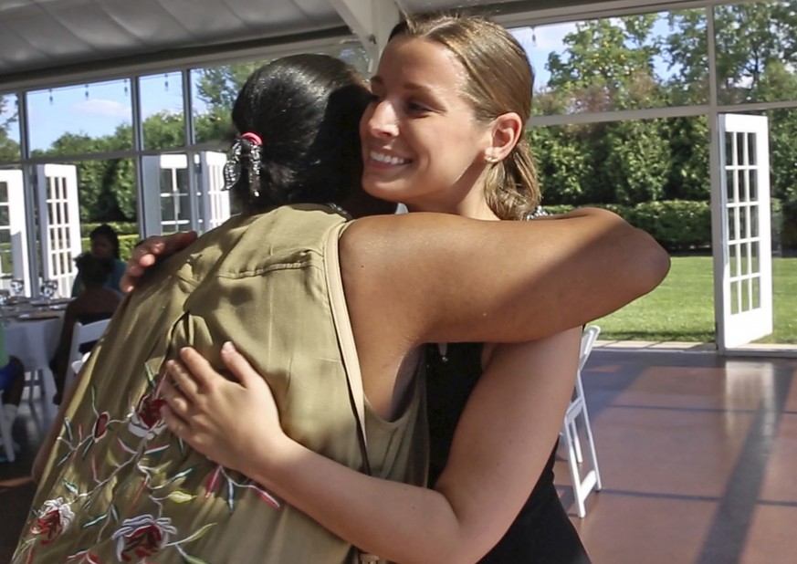 Janice Williamson-Cox, from Dayspring, left, hugs Sarah Cummins as she and others arrive at the Ritz Charles to enjoy a reception, Saturday, July 15, 2017. Cummins called off her wedding which was sup ...