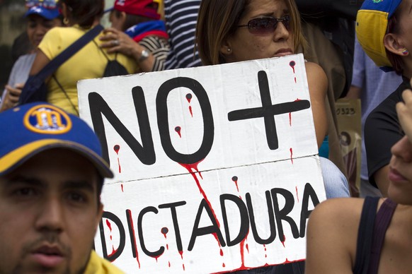 epa06141360 A view of a sign that reads &#039;No more dictatorship&#039; during an opposition protest against the Government in Caracas, Venezuela, 12 August 2017. Dozens of Venezuelans marched from d ...