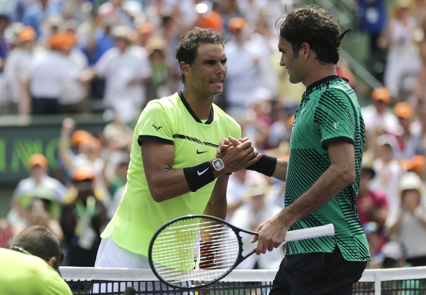 Rafael Nadal, left, of Spain, shakes hands with Roger Federer, of Switzerland, after the men&#039;s singles final at the Miami Open tennis tournament, Sunday, April 2, 2017, in Key Biscayne, Fla. (AP  ...
