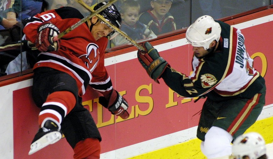 Minnesota Wild left wing Matt Johnson, right, checks New Jersey Devils defenseman Tommy Albelin (6) of Sweden into the boards during the first period Saturday, Jan. 26, 2002, in St. Paul, Minnesota. ( ...